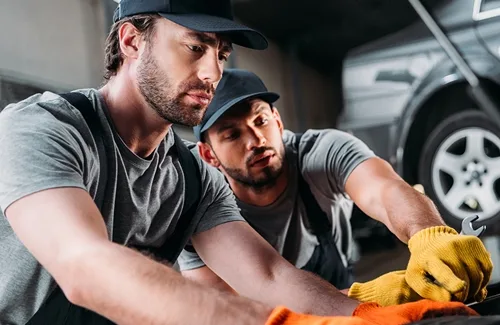 GM Car AC Service workshop interior — certified technicians repairing car AC system in Ambattur Chennai